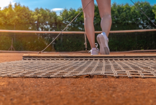 sweeping clay court